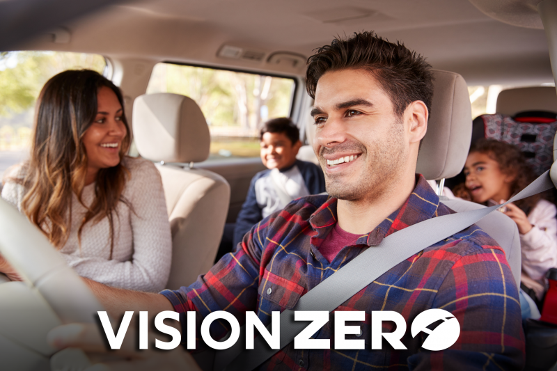 Family driving a car with Vision Zero logo.