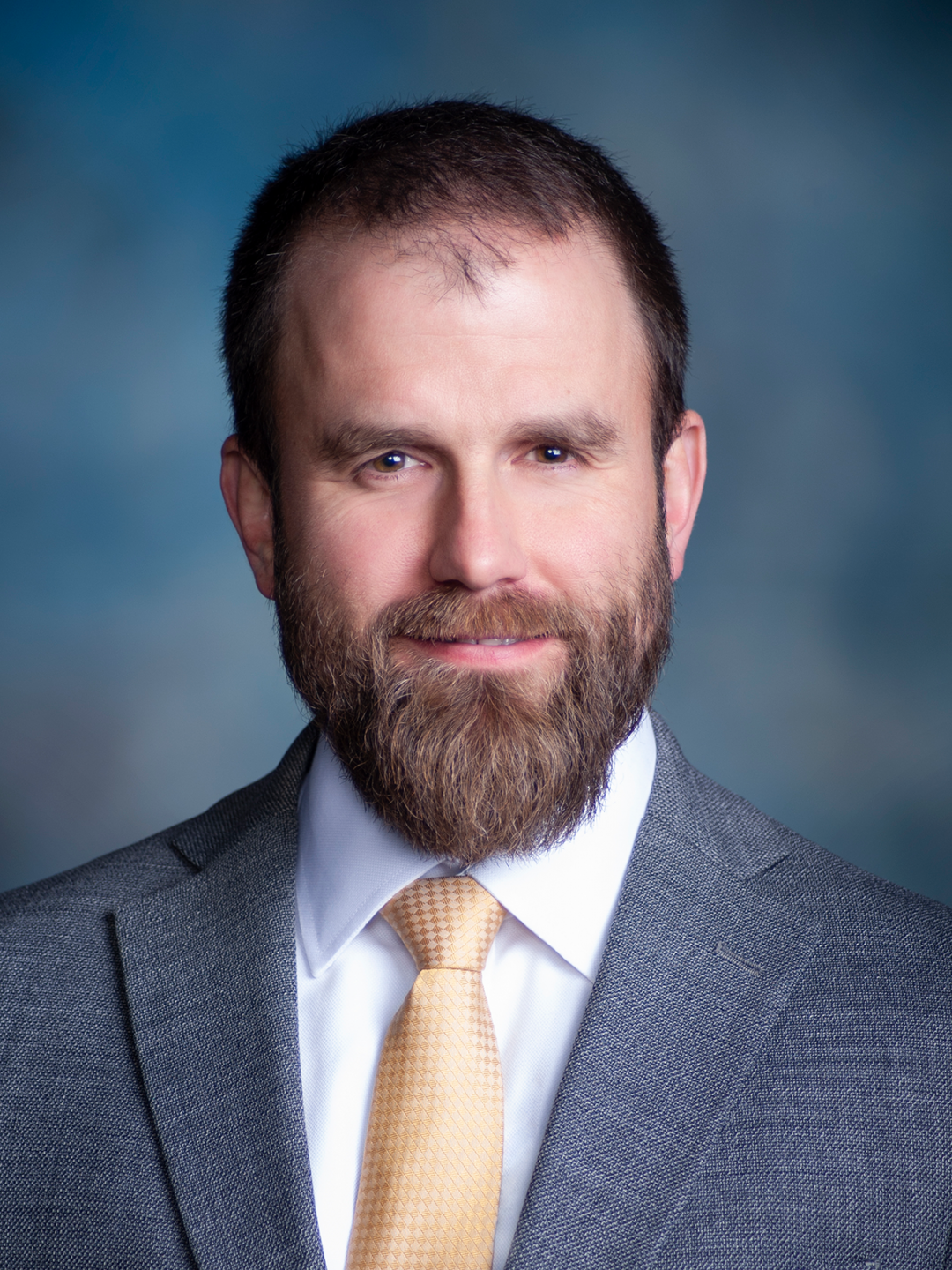 Smiling Matt Linneman, PE, Deputy Director for Engineering, bluish smoky gray background.