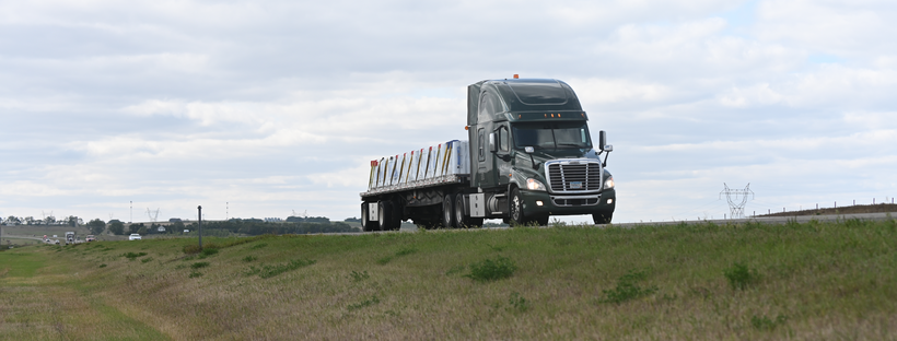 A semi drives down a highway