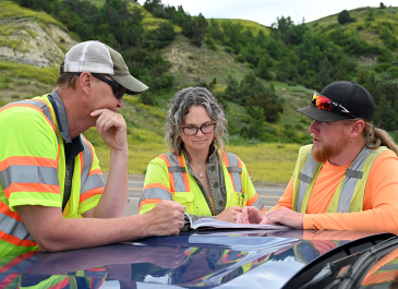 Consultant engineer discusses project with NDDOT team.