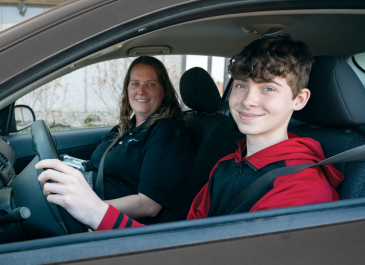 Driver seated in car, preparing for his driver license test.