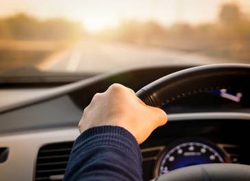 Person's hand on the steering wheel