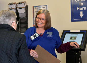 NDDOT employee helps citizen check in to an NDDOT site.