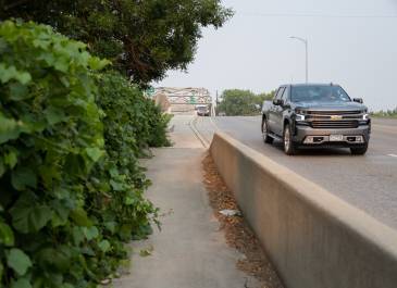 Vehicles coming over a bridge