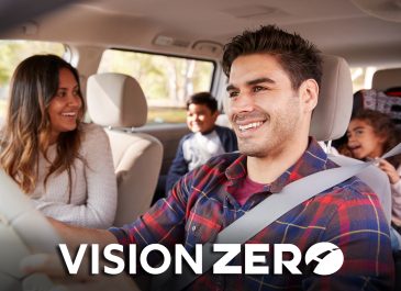 Happy family inside vehicle.