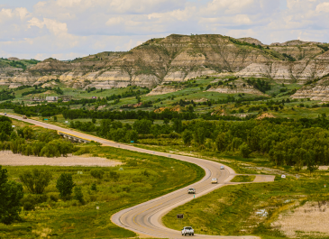 View of Theodore Roosevelt National Park and cars driving on Interstate 94.