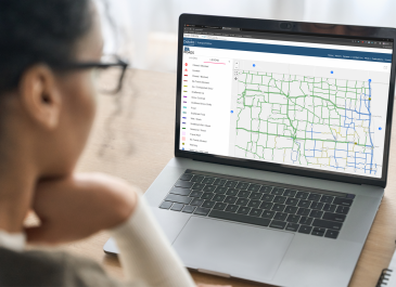Woman looking at ND Roads, the North Dakota travel map, on her laptop computer.