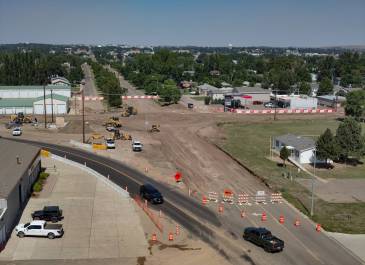 Aerial view of the ND Highway 22 and 8th Street roundabout construction in Dickinson, N.D., showing the work zone, temporary bypass, and pedestrian paths.