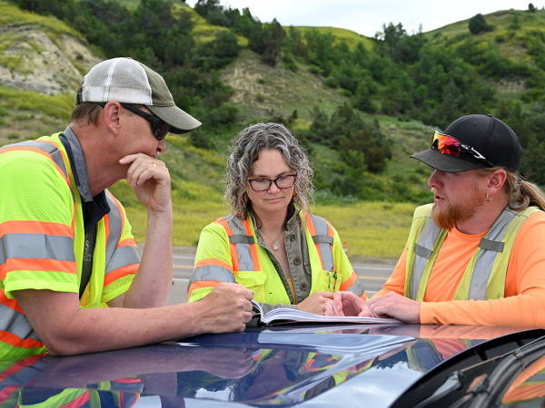 Consultant engineer discusses project with NDDOT team.