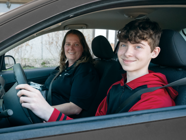 Driver seated in car, preparing for his driver license test.