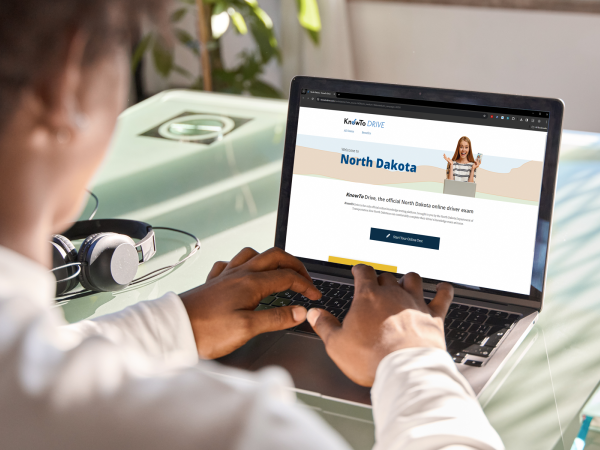 Teen on computer taking the NDDOT online knowledge test.