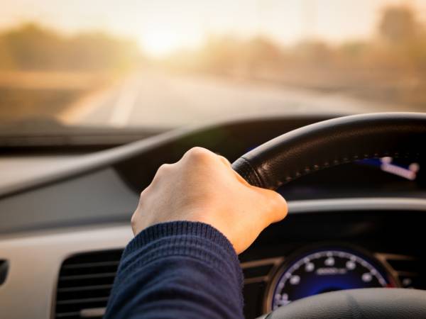 Person's hand on the steering wheel
