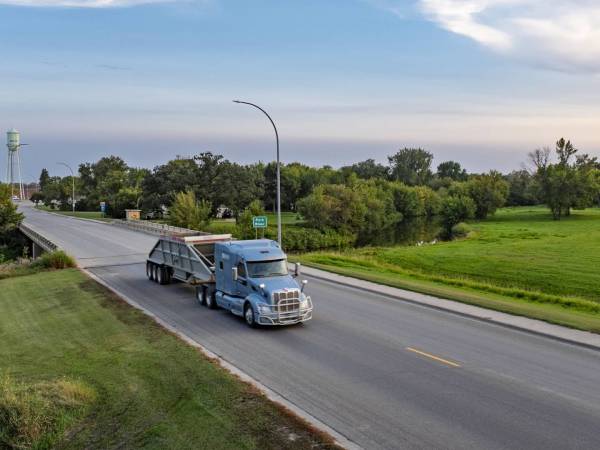 Truck driving over a bridge.