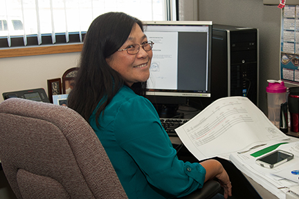 Marohl Seng sitting at her desk in the Bismarck central office. 