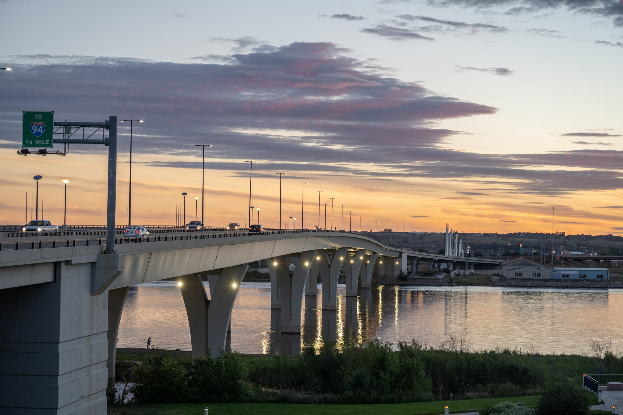 Traffic over bridge at sunset