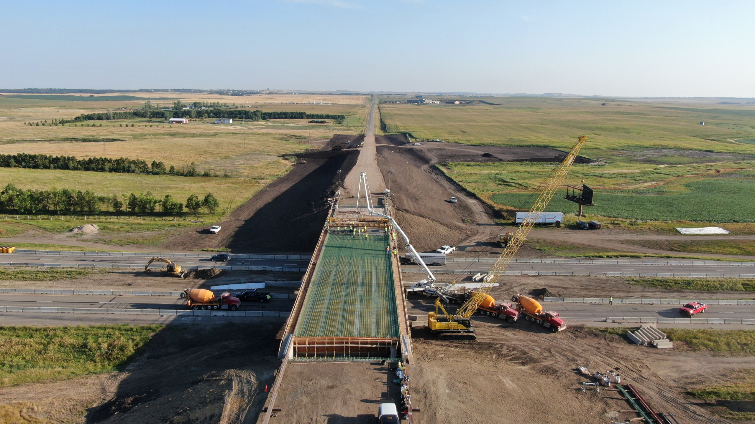 Bridge construction site, cement mixers, cranes.