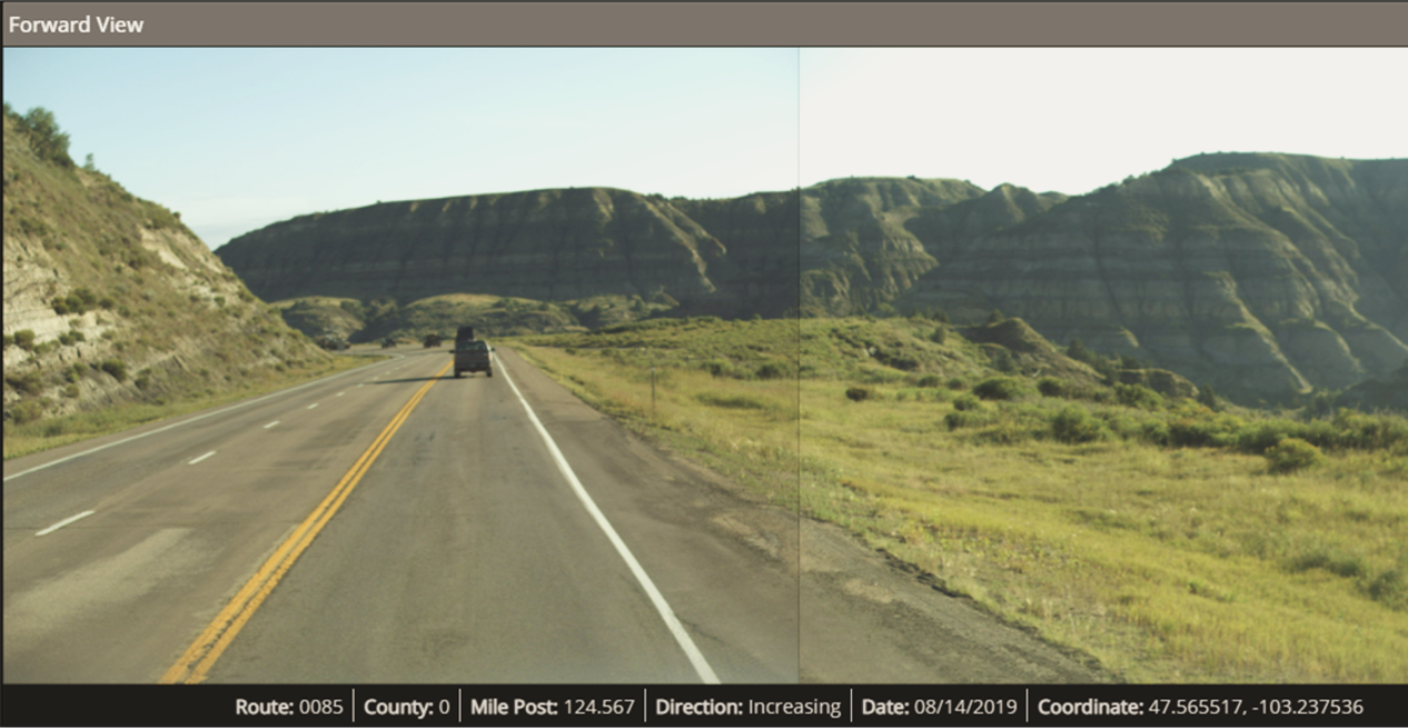 Forward view of a pavement on a road route in between mountains..