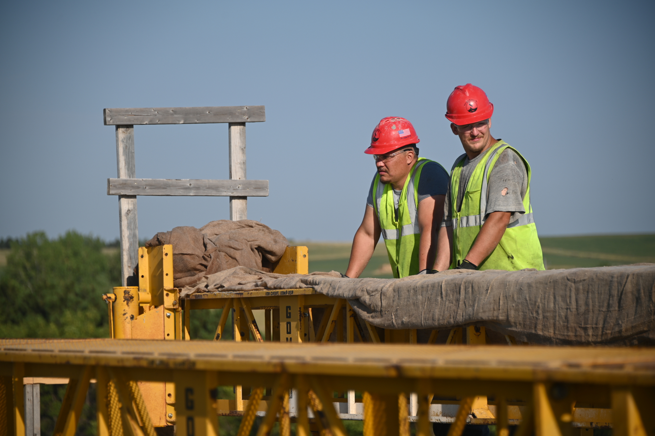 Photo of two construction workers on a job site.