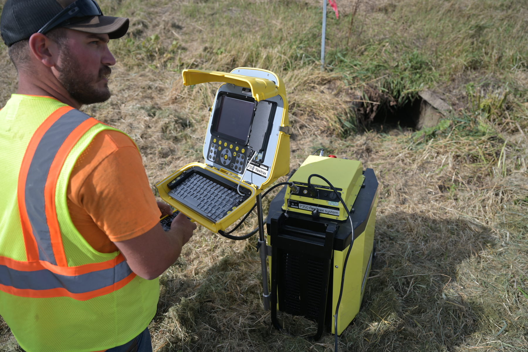 Pipe crawler technician checking a culvert.