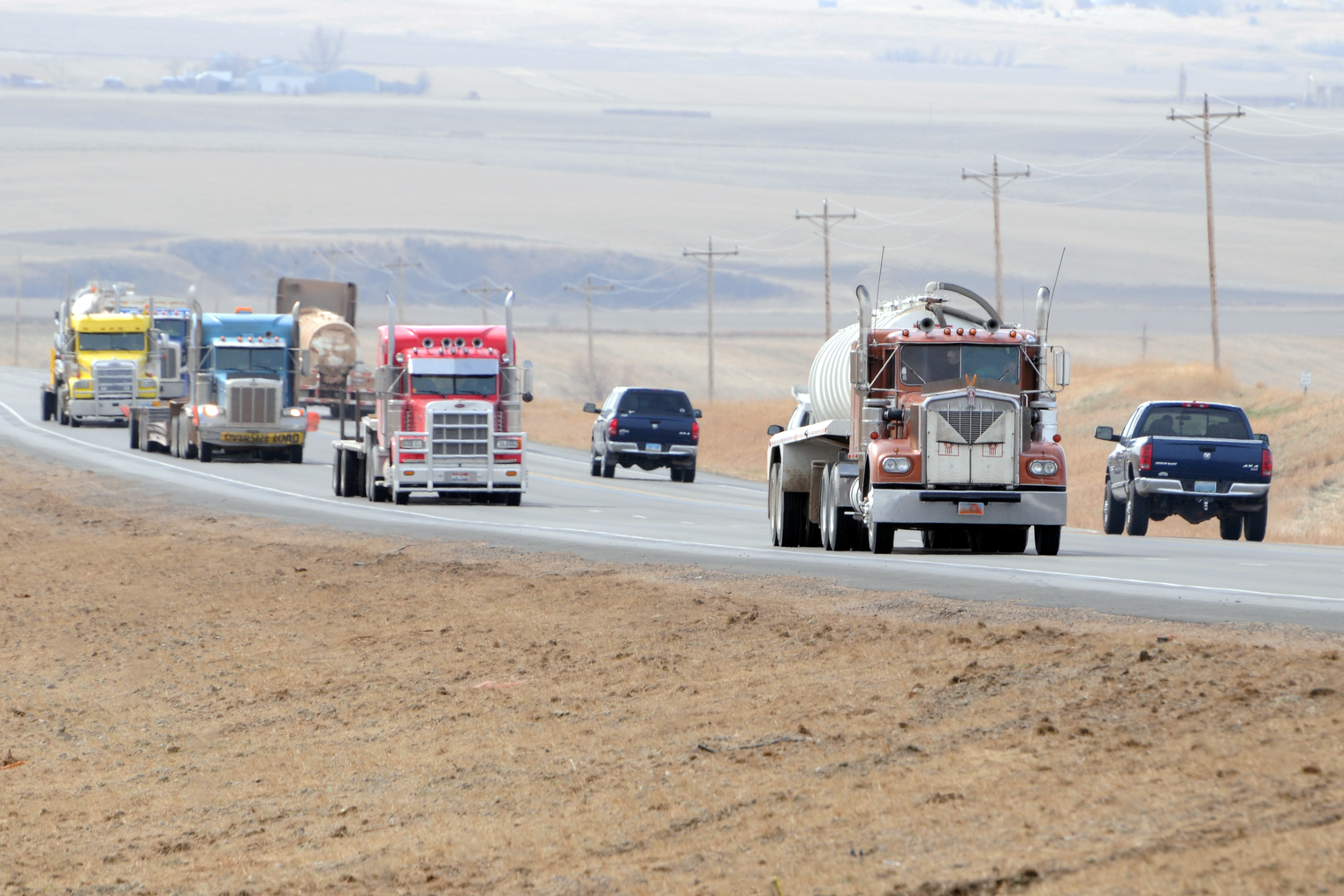 Semitrucks and pickups driving down a North Dakota highway.