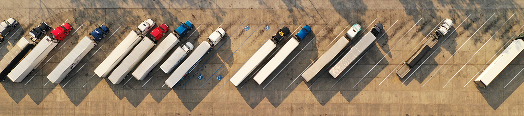 Semi trucks parked at a rest area.