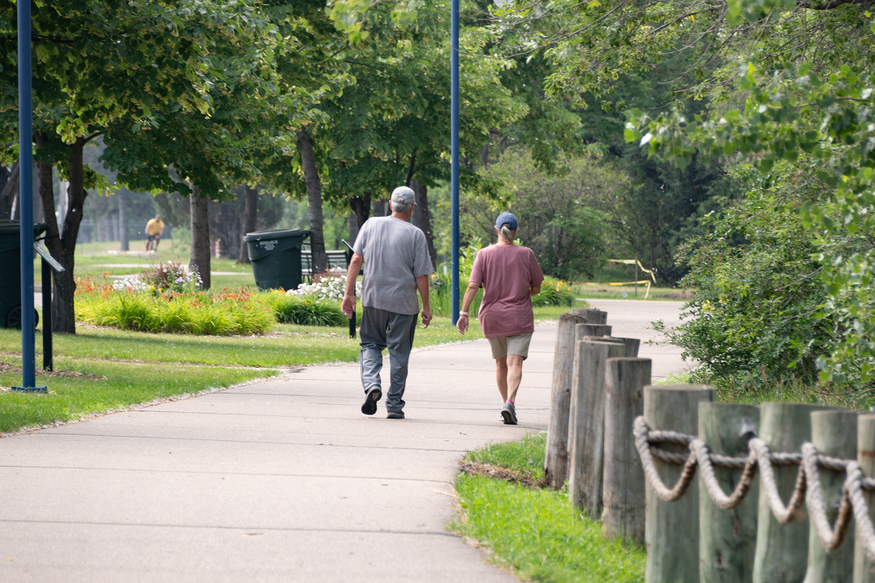 Couple walking down an urban walk path enjoying a beautiful North Dakota day.