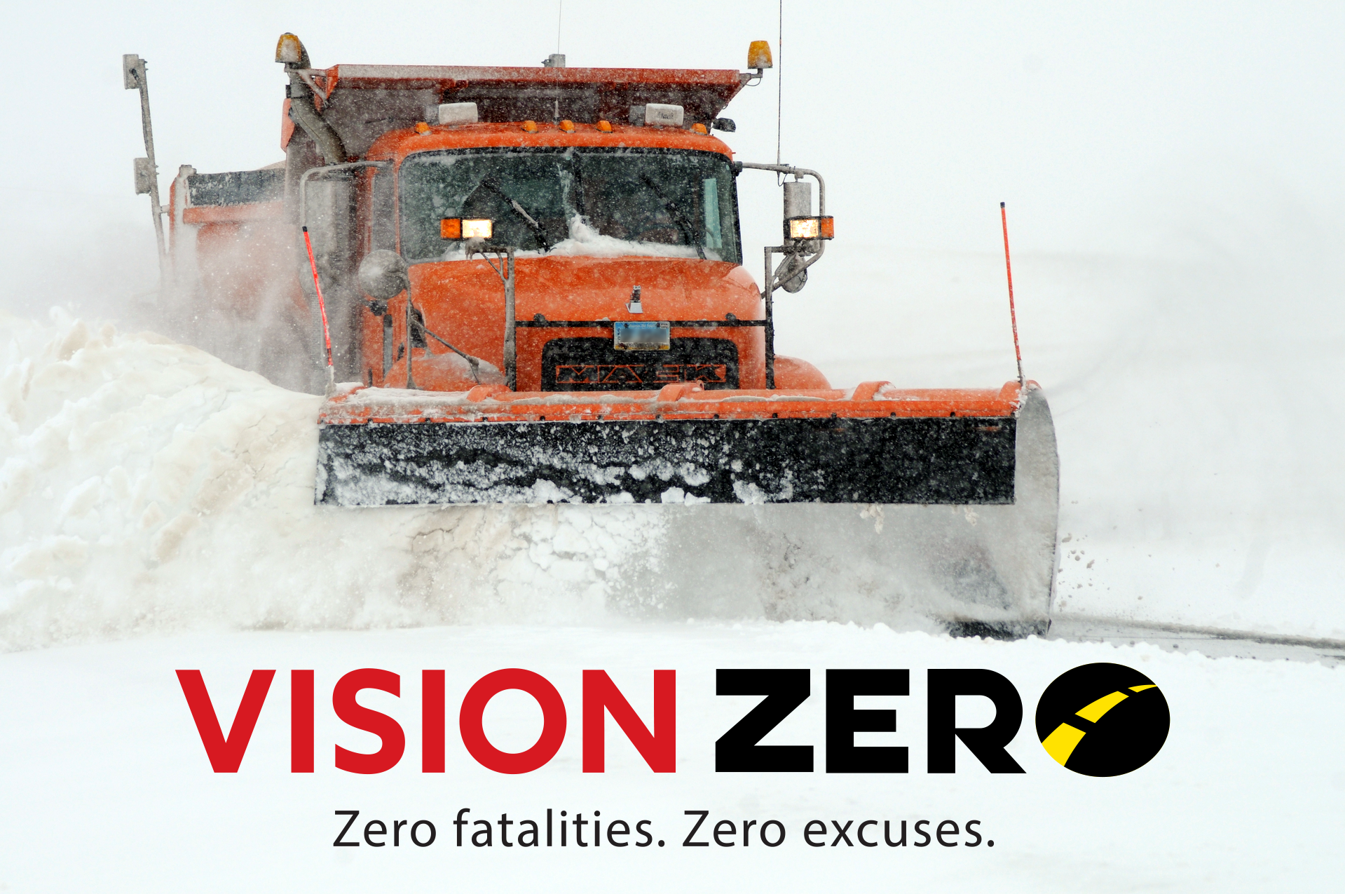 Snow plow pushing snow with Vision Zero logo.