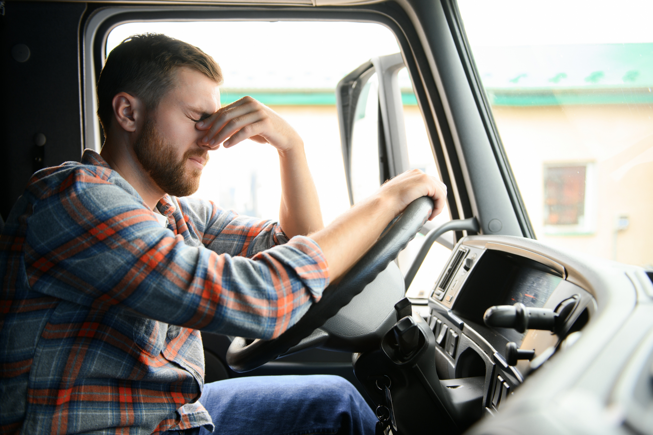 Tired driver suffering from a headache.