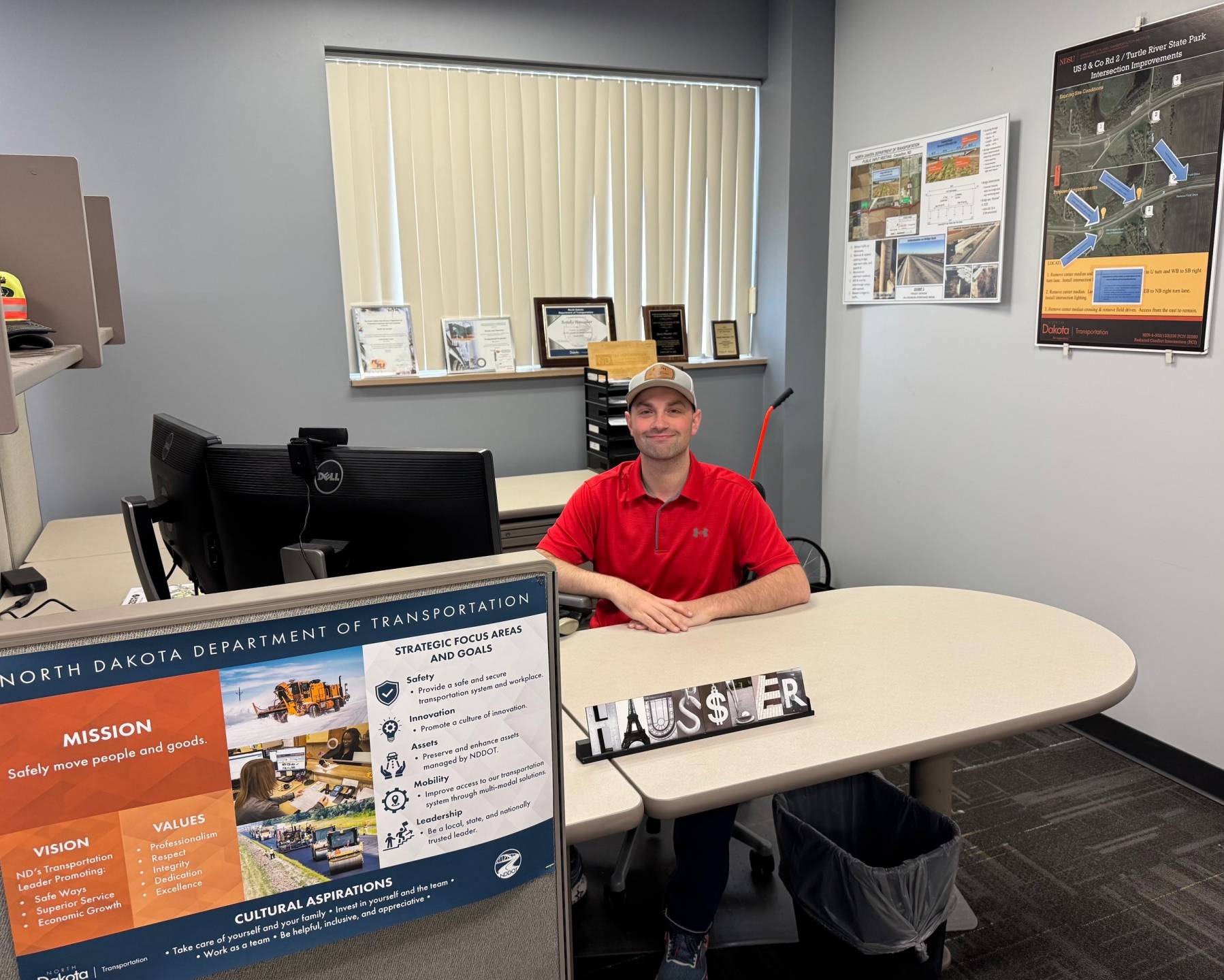 Brady Haussler sits at his desk