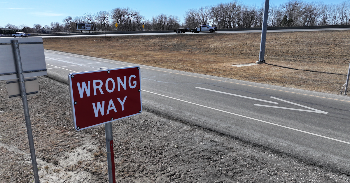 A red sign next to an offramp warns drivers they are going the wrong way