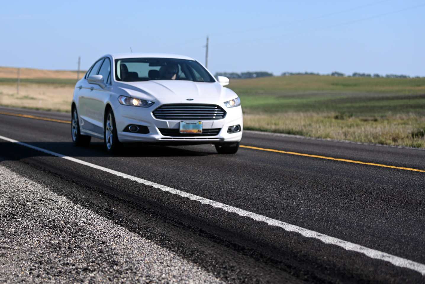 Photo shows car driving on Highway 32 and close up of rumble stripes.