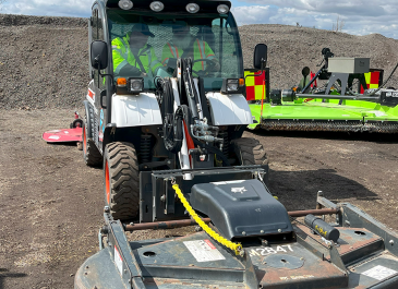 Driving a Bobcat with mower attachment