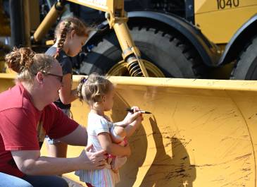Signing the plow at Touch-A-Truck in Hazen