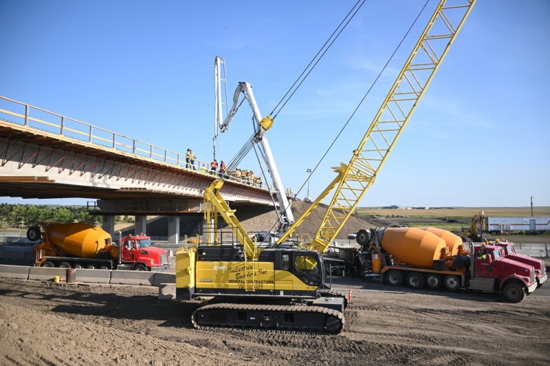 Crane and heavy construction equipment near bridge
