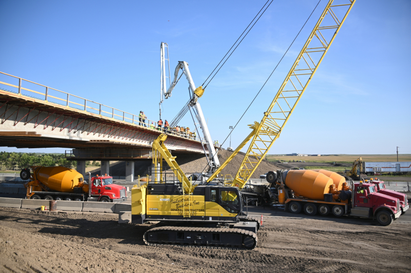 Crane and heavy construction equipment near bridge