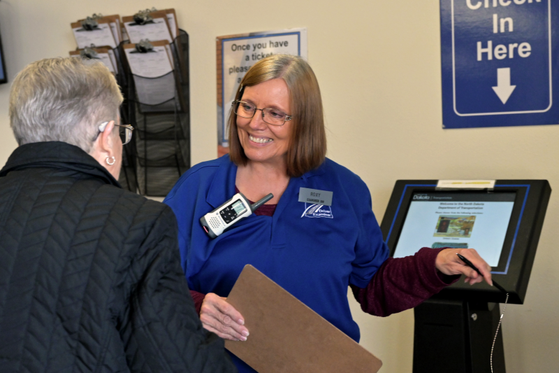 NDDOT employee helps citizen check in to an NDDOT site.