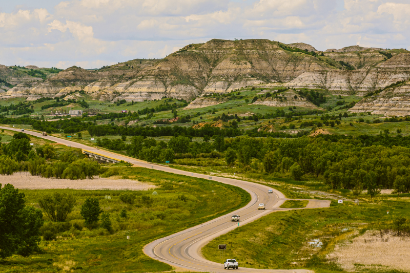 View of Theodore Roosevelt National Park and cars driving on Interstate 94.