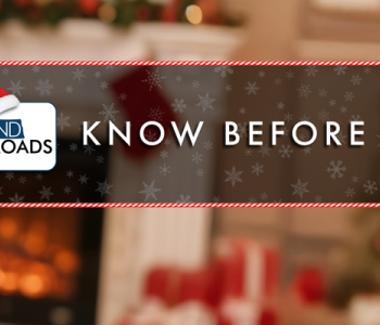 Santa holding a phone that has the ND Roads App displayed.